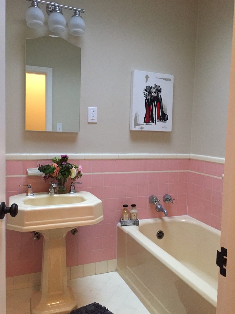 Vintage pink and cream tiled bathroom in a District 2 home.