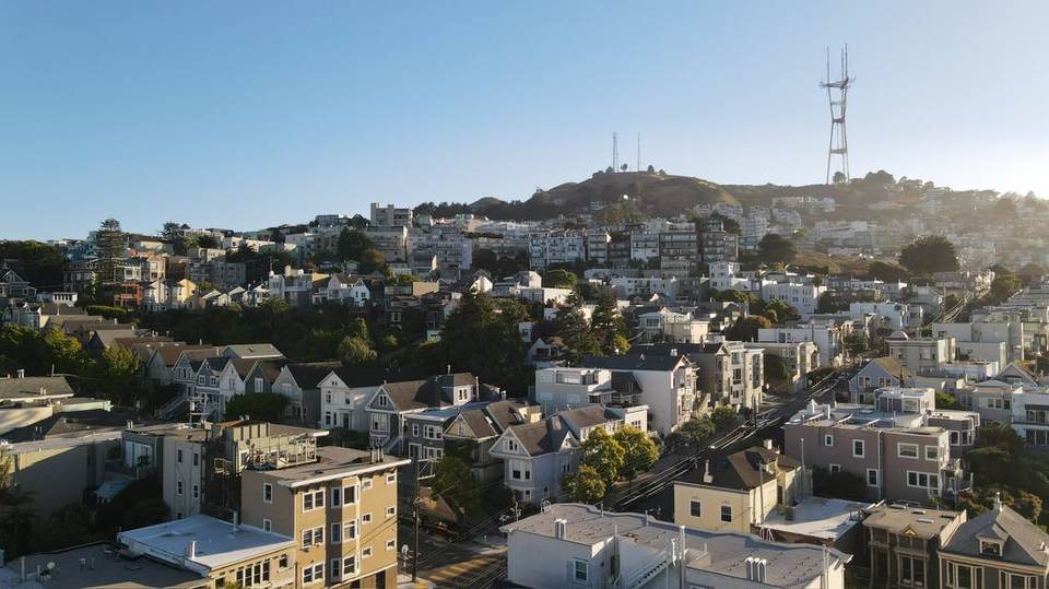 Evening light across homes on the east face of Twin Peaks.