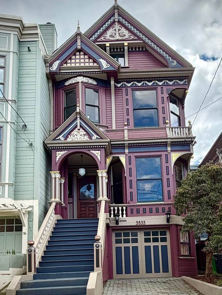 Three-story Queen Anne painted plum, slate and cream