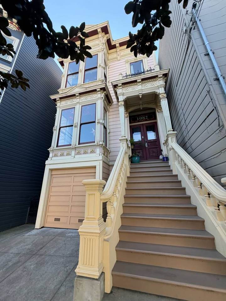 Pink Italianate Victorian with a tall front stair