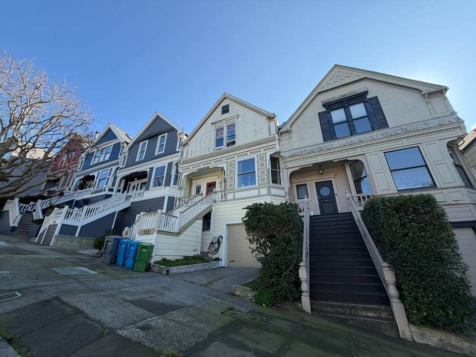 Row of Victorian cottages with high front stairs