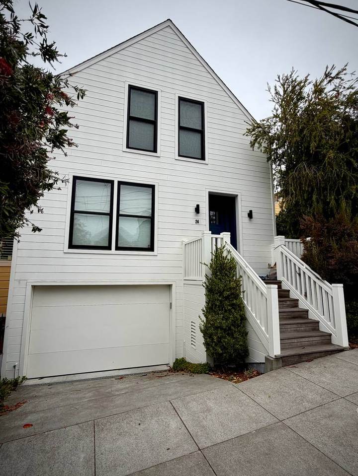 Modern white house with horizontal siding and black windows